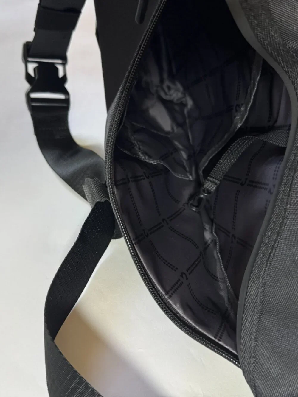 True Religion Black Sling Bag Features a Textured Black Logo Patch on the Front